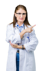 Poster - Middle age mature doctor woman wearing medical coat over isolated background Pointing with hand finger to the side showing advertisement, serious and calm face