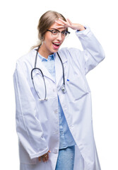 Canvas Print - Beautiful young blonde doctor woman wearing medical uniform over isolated background very happy and smiling looking far away with hand over head. Searching concept.