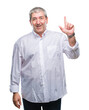 © Krakenimages.com - Handsome senior man over isolated background pointing finger up with successful idea. Exited and happy. Number one.