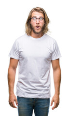 Sticker - Young handsome man with long hair wearing glasses over isolated background afraid and shocked with surprise expression, fear and excited face.