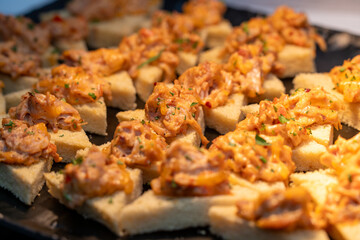 Wall Mural - Chicken bread bite appetizer. Shredded spicy chicken on crunch bread triangles