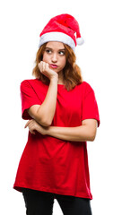 Sticker - Young beautiful woman over isolated background wearing christmas hat thinking looking tired and bored with depression problems with crossed arms.