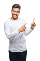 Sticker - Young handsome man over isolated background smiling and looking at the camera pointing with two hands and fingers to the side.