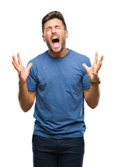 Canvas Print - Young handsome man over isolated background crazy and mad shouting and yelling with aggressive expression and arms raised. Frustration concept.