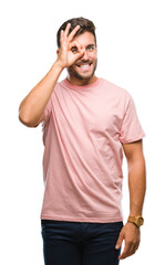 Poster - Young handsome man over isolated background doing ok gesture with hand smiling, eye looking through fingers with happy face.