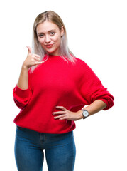 Sticker - Young blonde woman wearing winter sweater over isolated background smiling doing phone gesture with hand and fingers like talking on the telephone. Communicating concepts.