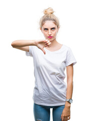 Canvas Print - Young beautiful blonde woman wearing white t-shirt over isolated background looking unhappy and angry showing rejection and negative with thumbs down gesture. Bad expression.