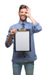 © Krakenimages.com - Young handsome business man holding clipboard over isolated background with happy face smiling doing ok sign with hand on eye looking through fingers