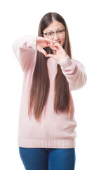 Wall Mural - Young Chinese woman over isolated background wearing glasses smiling in love showing heart symbol and shape with hands. Romantic concept.