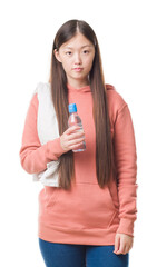 Sticker - Young Chinese woman over isolated background wearing sport sweathshirt with a confident expression on smart face thinking serious