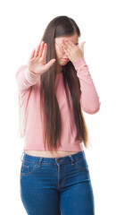 Sticker - Young Chinese woman over isolated background wearing glasses covering eyes with hands and doing stop gesture with sad and fear expression. Embarrassed and negative concept.