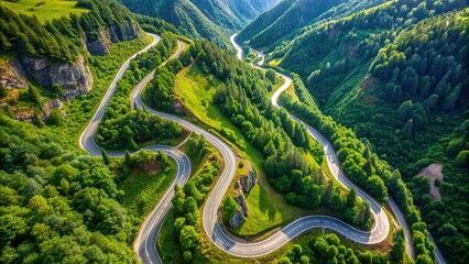 Wall Mural - Aerial view of a winding road in the mountains surrounded by lush greenery, aerial, view, road, winding, mountains