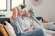 © Daniel - Peaceful middle aged man and woman with closed eyes relaxing on comfortable couch at home, mature family daydreaming together, grey haired wife and husband resting with hands behind head, breathing.