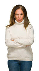 Sticker - Beautiful middle age adult woman wearing winter sweater over isolated background skeptic and nervous, disapproving expression on face with crossed arms. Negative person.