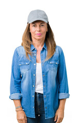Wall Mural - beautiful middle age woman wearing sport cap over isolated background relaxed with serious expressio