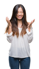 Canvas Print - Young asian woman over isolated background celebrating mad and crazy for success with arms raised and closed eyes screaming excited. Winner concept