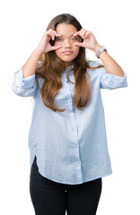 Poster - Young beautiful brunette business woman over isolated background Trying to open eyes with fingers, sleepy and tired for morning fatigue