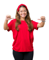 Wall Mural - Young beautiful brunette woman wearing red t-shirt over isolated background looking confident with smile on face, pointing oneself with fingers proud and happy.