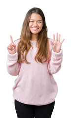 Poster - Young beautiful brunette woman wearing pink winter sweater over isolated background showing and pointing up with fingers number six while smiling confident and happy.