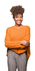 Wall Mural - Beautiful young african american woman over isolated background happy face smiling with crossed arms looking at the camera. Positive person.