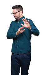 Canvas Print - Young handsome business man wearing glasses over isolated background disgusted expression, displeased and fearful doing disgust face because aversion reaction. With hands raised. Annoying concept.