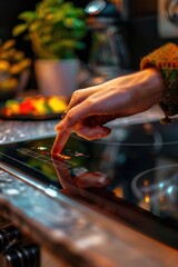 Poster - A person touches a button on a stove top