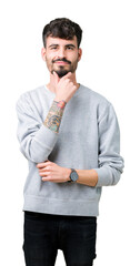 Sticker - Young handsome man wearing sweatshirt over isolated background looking confident at the camera with smile with crossed arms and hand raised on chin. Thinking positive.