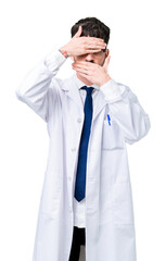 Canvas Print - Young professional scientist man wearing white coat over isolated background Covering eyes and mouth with hands, surprised and shocked. Hiding emotion