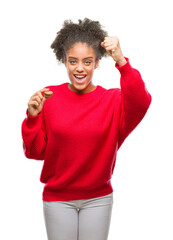 Poster - Young afro american woman eating chocolate macaron over isolated background annoyed and frustrated shouting with anger, crazy and yelling with raised hand, anger concept