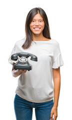 Sticker - Young asian woman holding vintagera telephone over isolated background with a happy face standing and smiling with a confident smile showing teeth