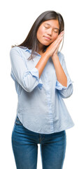 Poster - Young asian business woman over isolated background sleeping tired dreaming and posing with hands together while smiling with closed eyes.