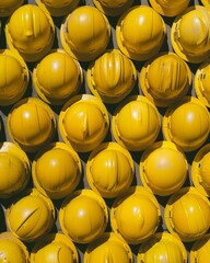 Poster - Top-Down Symmetrical Display of Yellow Construction Helmets with Detailed Texture and Geometric Arrangement