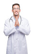 © Krakenimages.com - Handsome young doctor man praying with hands together asking for forgiveness smiling confident.
