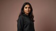 © StockFlow - Indian woman wearing black sweatshirt; positioned on the pastel background corner, perfect for text