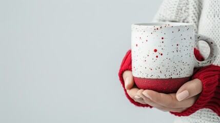 Poster - compact artistic coffee cup with craggy stratified texture in bright red and white creative silhouette female model's hands cradling the cup in minimalist pose clean white background studio lighting