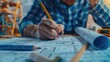 © pitu - Concept architects, engineer holding pen pointing equipment architects On the desk with a blueprint in the office, Vintage, Sunset light.Selective Focus