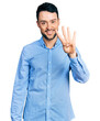 © Krakenimages.com - Hispanic man with beard wearing casual business shirt showing and pointing up with fingers number four while smiling confident and happy.