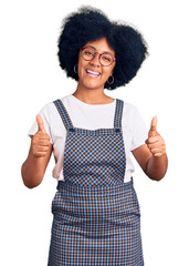 Poster - Young african american girl wearing casual clothes success sign doing positive gesture with hand, thumbs up smiling and happy. cheerful expression and winner gesture.