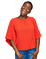 Poster - Young african american woman wearing casual clothes winking looking at the camera with sexy expression, cheerful and happy face.