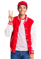 Canvas Print - Young african amercian man wearing baseball uniform showing and pointing up with fingers number three while smiling confident and happy.