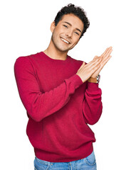 Wall Mural - Young handsome man wearing casual clothes clapping and applauding happy and joyful, smiling proud hands together