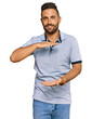 © Krakenimages.com - Handsome man with beard wearing casual clothes gesturing with hands showing big and large size sign, measure symbol. smiling looking at the camera. measuring concept.