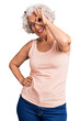 © Krakenimages.com - Senior grey-haired woman wearing casual clothes smiling happy doing ok sign with hand on eye looking through fingers