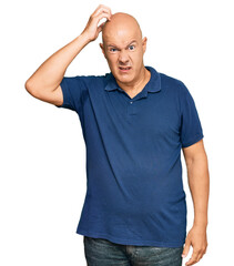 Wall Mural - Middle age bald man wearing casual clothes confuse and wonder about question. uncertain with doubt, thinking with hand on head. pensive concept.