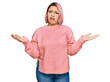 © Krakenimages.com - Hispanic woman with pink hair wearing casual winter sweater clueless and confused with open arms, no idea concept.