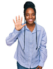 Canvas Print - Young african american woman wearing casual clothes showing and pointing up with fingers number five while smiling confident and happy.