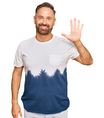 Sticker - Handsome middle age man wearing casual tie dye tshirt showing and pointing up with fingers number five while smiling confident and happy.