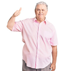 Wall Mural - Senior grey-haired man wearing casual clothes smiling happy and positive, thumb up doing excellent and approval sign