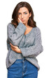 © Krakenimages.com - Young brunette woman wearing casual winter sweater thinking looking tired and bored with depression problems with crossed arms.