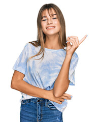 Wall Mural - Teenager caucasian girl wearing casual clothes smiling happy pointing with hand and finger to the side